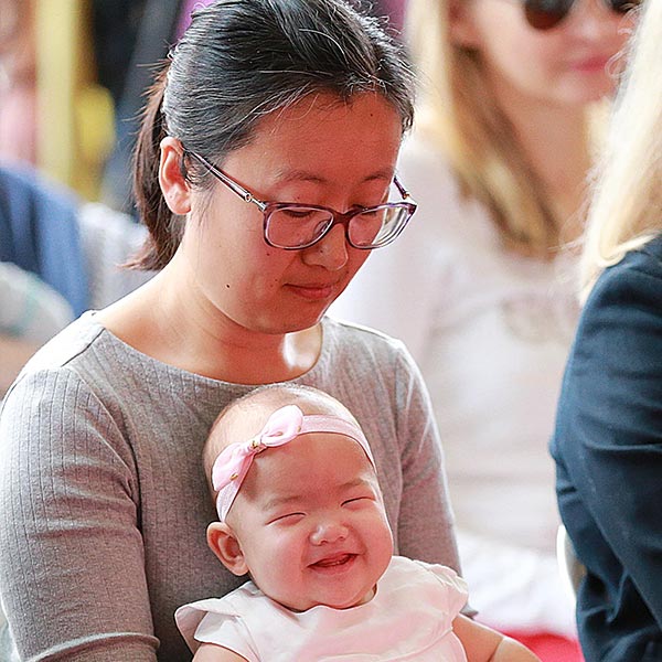 Mum with baby attending the baby blessing ceremony